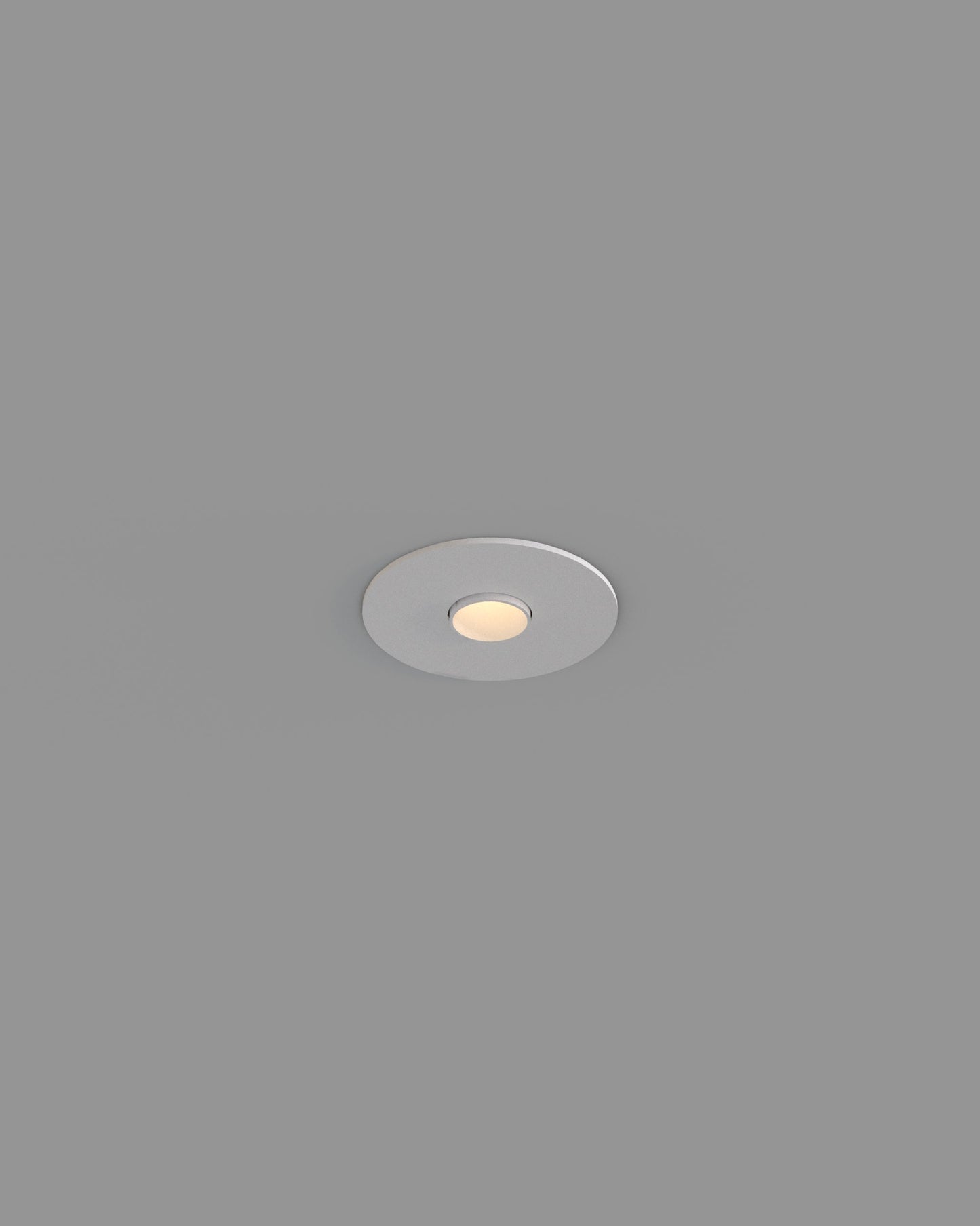 Luz empotrable de techo circular blanca, encendida, sobre fondo gris, iluminación interior.
