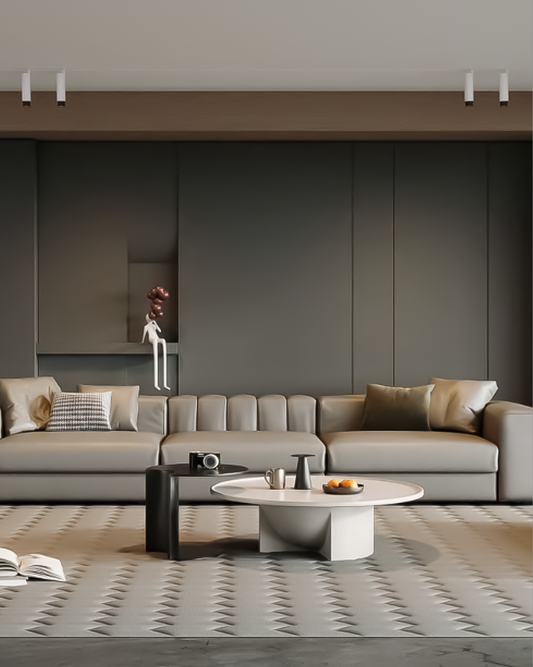 Sala moderna con sofá gris, mesa de centro redonda y lámparas de techo minimalistas