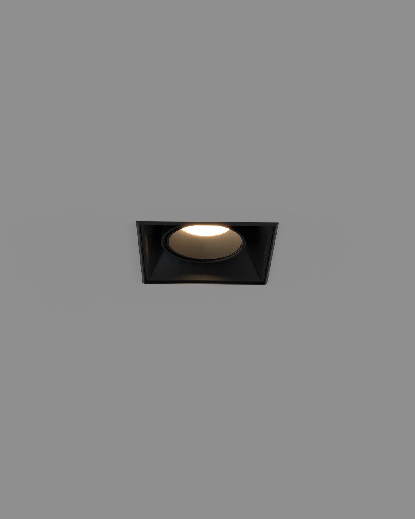 Downlight empotrable negro trimless cuadrado moderno, encendido, sobre fondo gris.