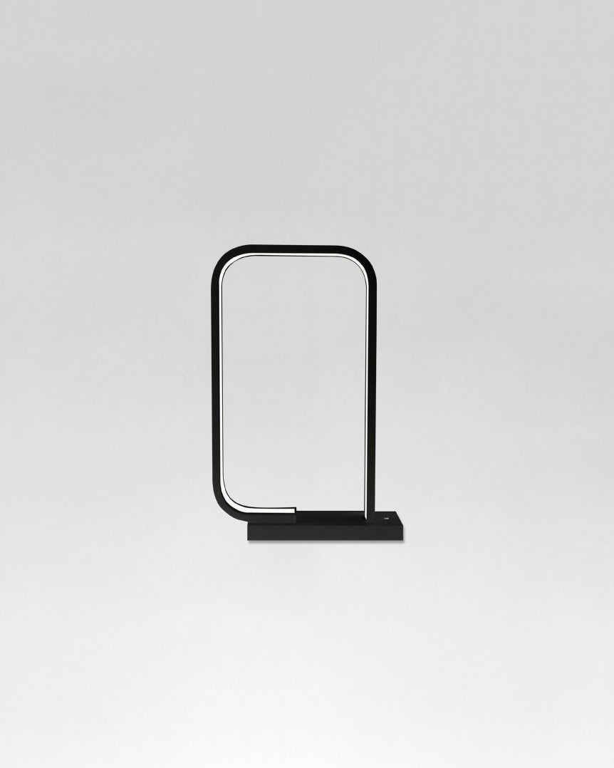 Lámpara de mesa moderna minimalista negra con forma rectangular sobre fondo gris.