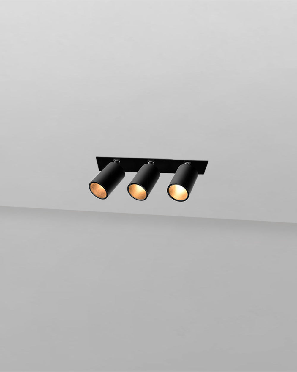 Lámpara de techo moderna con tres focos cilíndricos negros para iluminación interior