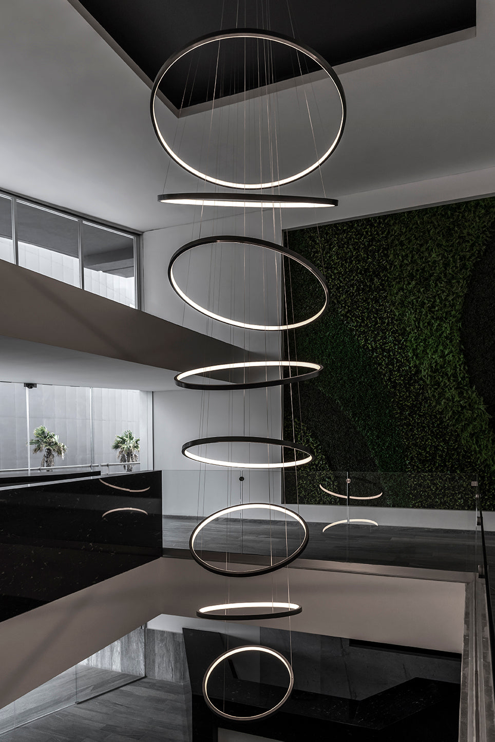Lámpara colgante moderna de aros LED en escalera de interior elegante