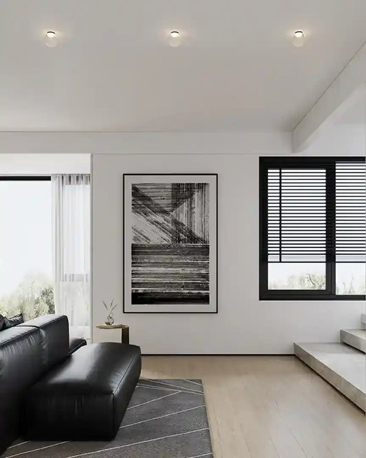 Sala moderna con iluminación LED de plafón trimless, sofá negro y decoración minimalista, Birot MX