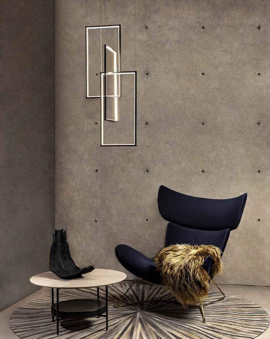 Lámparas geométricas modernas, sillón oscuro con manta y mesa en ambiente minimalista, Birot MX