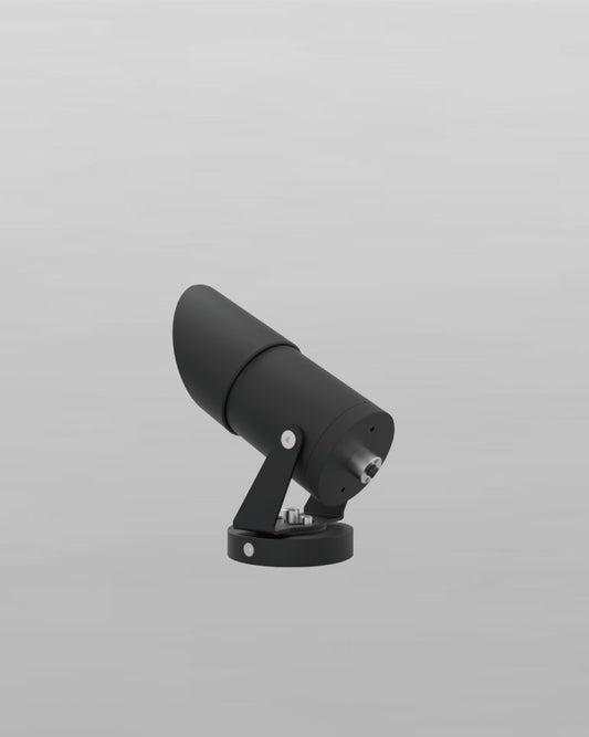 Proyector LED negro de exterior sobre fondo gris, diseño moderno para iluminación decorativa