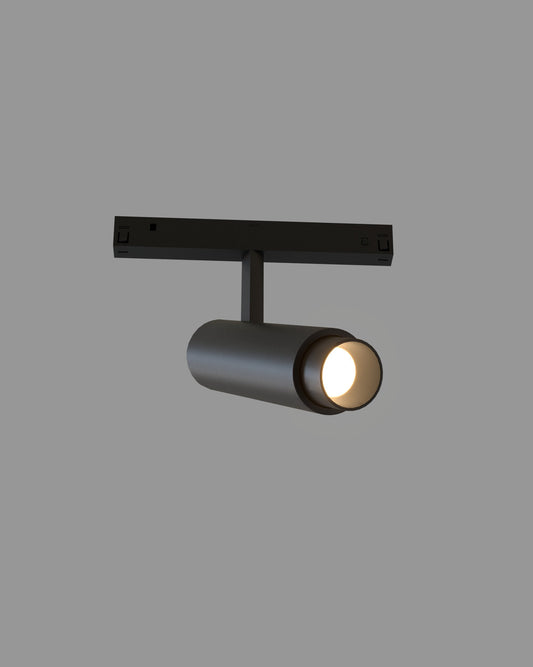 Lámpara de riel negro moderna, iluminación de boutique Birot MX, fondo gris.