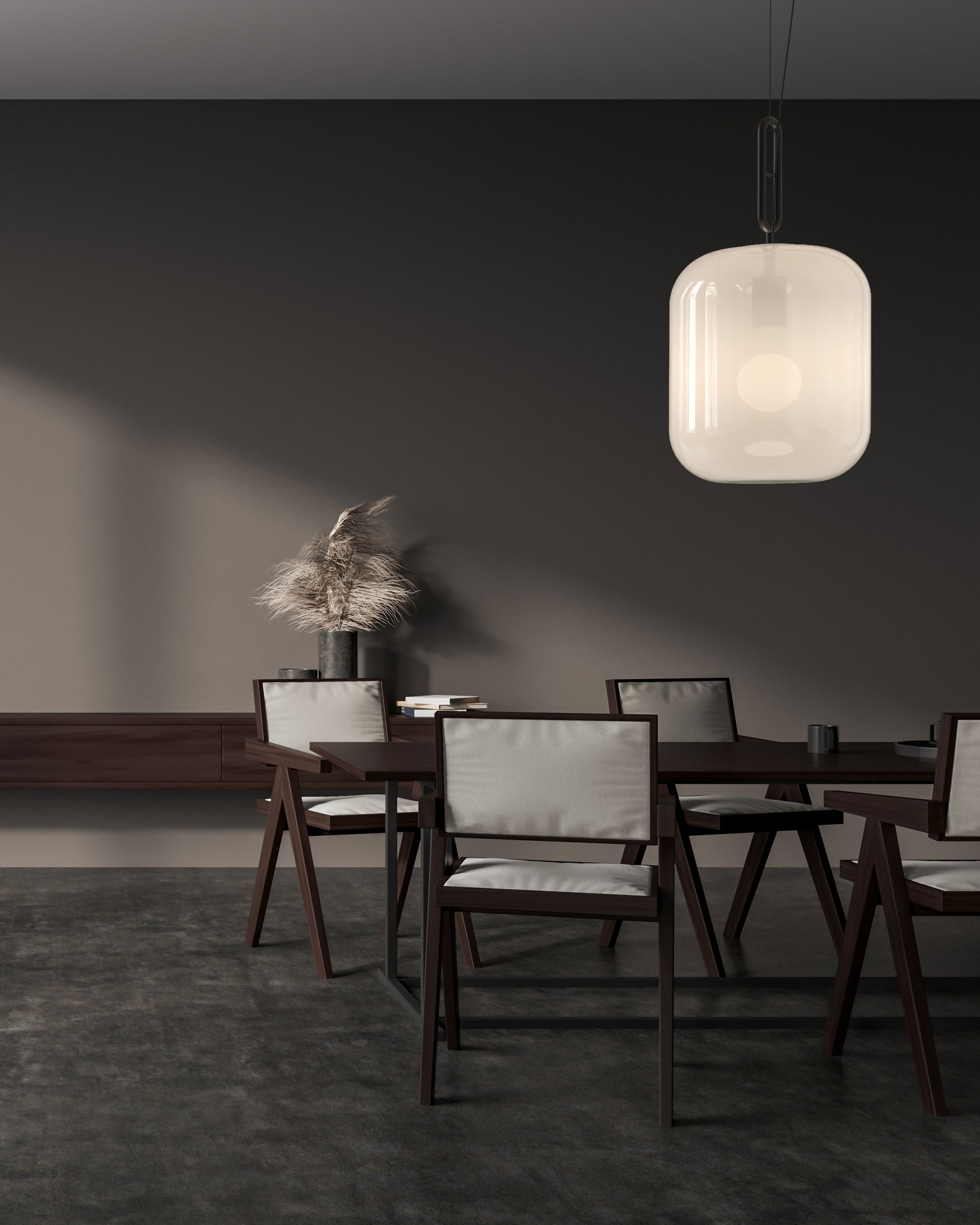 Lámpara de diseño moderno sobre comedor elegante, muebles oscuros y decoración minimalista.