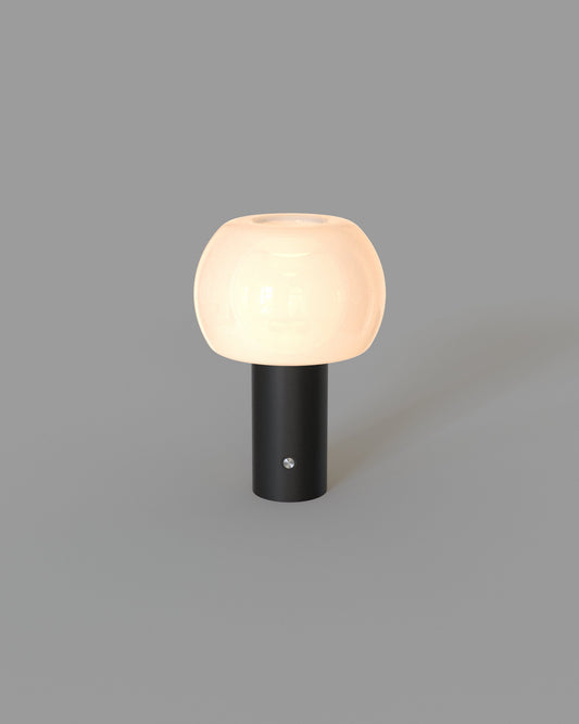 Lámpara de mesa moderna con base cilíndrica negra y pantalla redonda blanca, iluminación decorativa