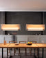 Lámparas modernas colgantes sobre mesa de comedor de madera en interior elegante, Birot MX iluminación boutique.