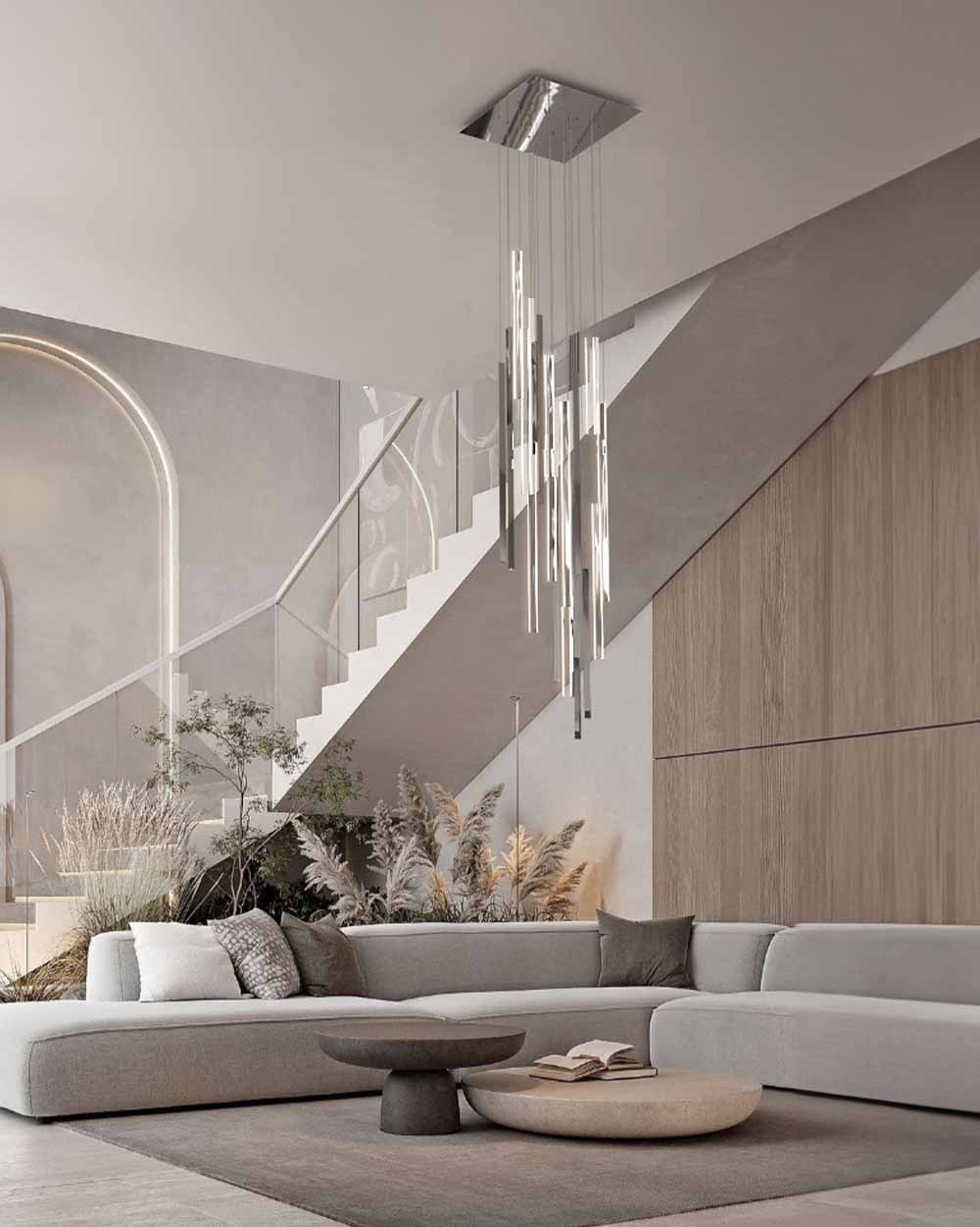 Lámpara colgante moderna en sala minimalista con sofá gris y mesa de centro redonda.