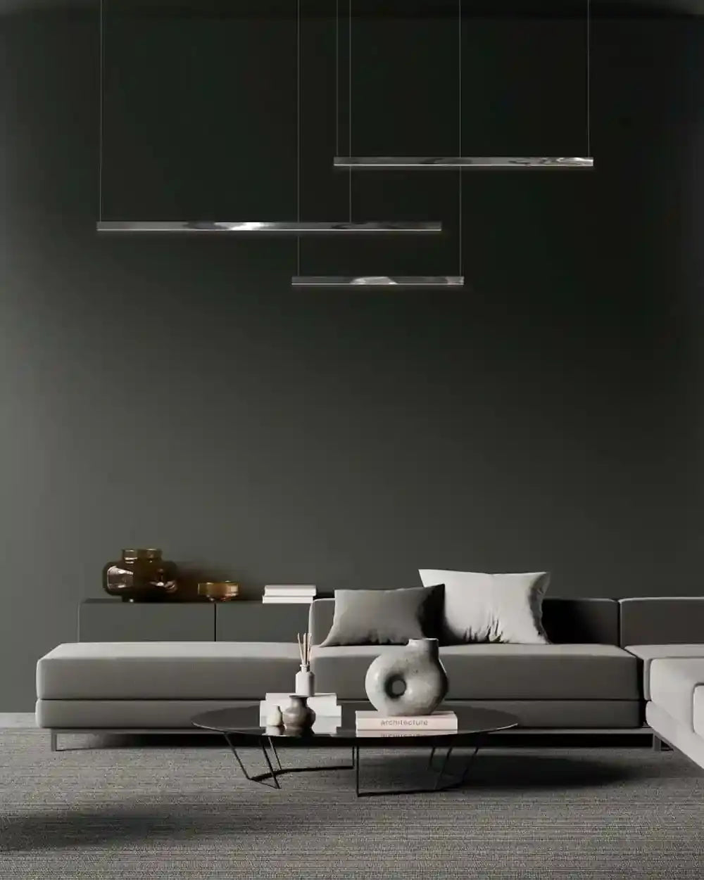 Sala moderna con sofá gris, mesa de centro y lámpara colgante minimalista.