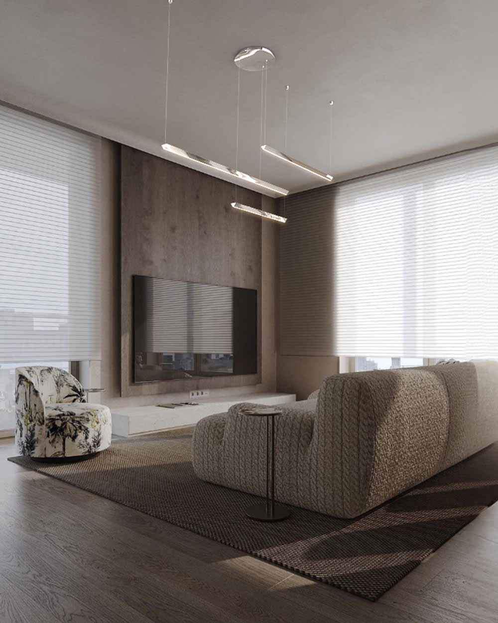 Sala moderna con lámpara colgante LED, sofá tapizado y sillón estampado, luz natural