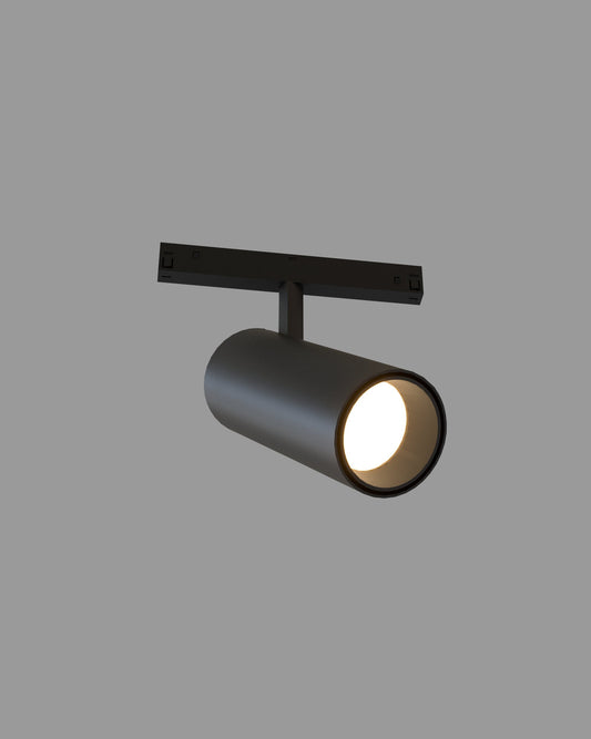 Spot de riel negro moderno para iluminación interior, encendido sobre fondo gris