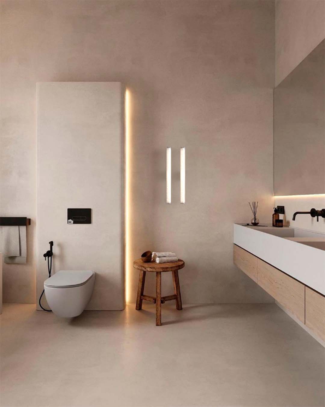 Baño moderno minimalista con iluminación LED, lavabo flotante y sanitario suspendido.