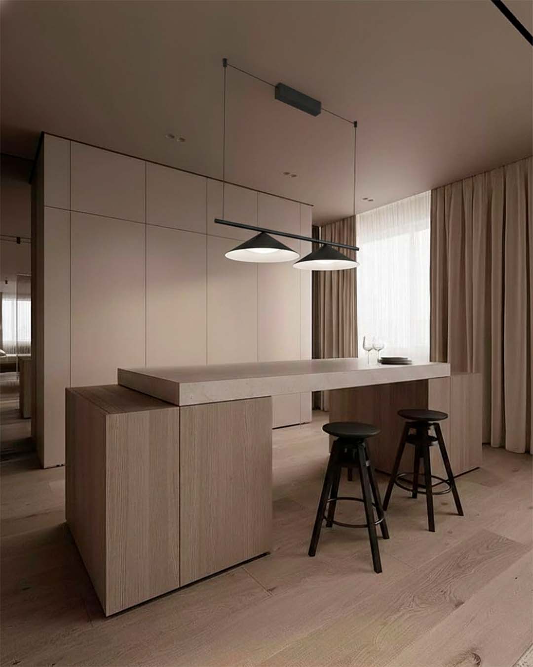 Lámparas colgantes modernas sobre isla de cocina minimalista en ambiente elegante