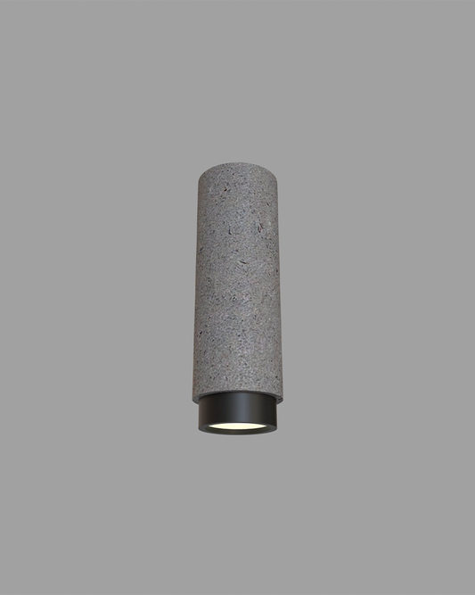 Lámpara de techo cilíndrica gris de cemento con base negra, iluminación moderna.