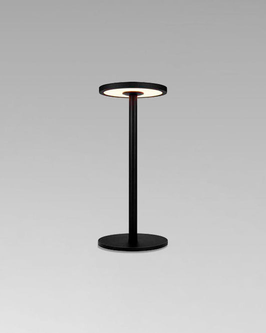 Lámpara de mesa negra moderna con base redonda y luz LED encendida sobre fondo gris