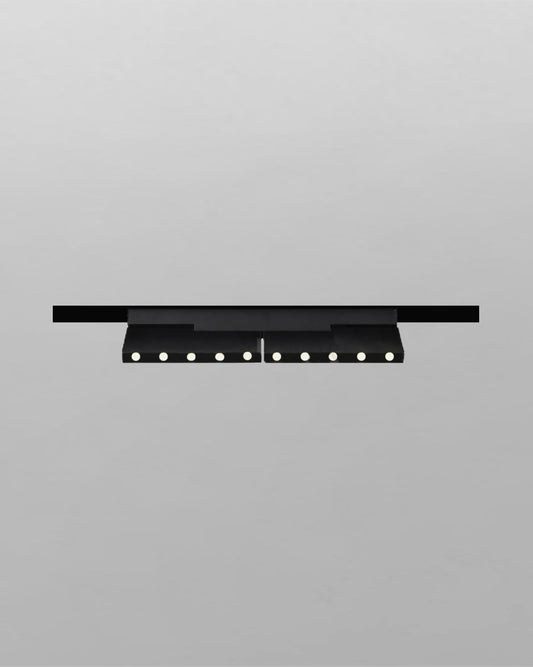 Luminario de techo negro moderno con focos LED encastrados sobre fondo gris.